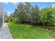 Lush backyard featuring a well-maintained lawn and mature landscaping at 10819 Savona Way, Orlando, FL 32827