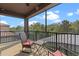 Relaxing balcony with furniture, a peaceful view of landscaping, and a screen enclosure for privacy at 10819 Savona Way, Orlando, FL 32827