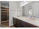 Bathroom features double sinks, quartz counters, dark cabinets and glass shower at 10819 Savona Way, Orlando, FL 32827