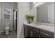 Bathroom featuring tile flooring, a glass shower, and a modern vanity with a quartz countertop at 10819 Savona Way, Orlando, FL 32827