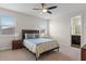 Bedroom featuring a bed with blue accents, and an attached bathroom at 10819 Savona Way, Orlando, FL 32827