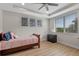 Bright bedroom featuring wood floors, tray ceilings and a large window with views at 10819 Savona Way, Orlando, FL 32827