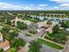 Aerial view of community center with pool, clock tower, and tropical landscaping at 10819 Savona Way, Orlando, FL 32827