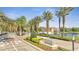 Gated community entrance with lush landscaping and decorative water features at 10819 Savona Way, Orlando, FL 32827