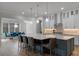 Open kitchen with white cabinetry, stainless appliances, and island with seating for entertaining at 10819 Savona Way, Orlando, FL 32827