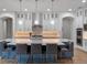 Gourmet kitchen featuring modern appliances, a large island with barstool seating, and elegant pendant lighting at 10819 Savona Way, Orlando, FL 32827