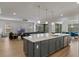 Spacious open-concept kitchen with gray cabinets, large island, stainless steel appliances, and hardwood flooring at 10819 Savona Way, Orlando, FL 32827