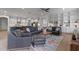 Open concept living room with spacious seating, island with barstools, and modern appliances at 10819 Savona Way, Orlando, FL 32827