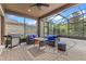 Screened patio with comfortable seating, a stainless steel grill, and view to backyard landscaping at 10819 Savona Way, Orlando, FL 32827