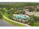 Aerial view of the clover-shaped community pool, surrounded by lush landscaping and lounge chairs at 10819 Savona Way, Orlando, FL 32827