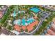Aerial view showcasing the community's resort-style pool, clubhouse, and tennis facilities at 1115 Oak Bluff Dr, Davenport, FL 33837