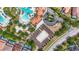 Aerial view showcasing a community sand volleyball court, pool, and residential areas at 1115 Oak Bluff Dr, Davenport, FL 33837