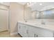 Bathroom with dual vanity, white cabinets, and a large mirror at 1115 Oak Bluff Dr, Davenport, FL 33837