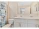 Bathroom with double sinks and a mirror, featuring a blue shower curtain at 1115 Oak Bluff Dr, Davenport, FL 33837