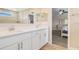 Modern bathroom boasts dual sinks, quartz countertops, and an open view to the primary bedroom at 1115 Oak Bluff Dr, Davenport, FL 33837