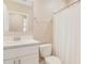Bathroom featuring a toilet and sink with a white shower curtain on a rod at 1115 Oak Bluff Dr, Davenport, FL 33837