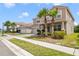 Charming two-story home features a two car garage, tile roof, front yard landscaping and brick paved drive at 1115 Oak Bluff Dr, Davenport, FL 33837