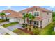 Charming two-story home features a two car garage, tile roof, front yard landscaping and brick paved drive at 1115 Oak Bluff Dr, Davenport, FL 33837