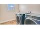 Laundry room with side by side washing machine and dryer and a window with natural light at 1115 Oak Bluff Dr, Davenport, FL 33837