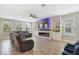 Spacious living room with a fireplace, modern lighting, and tile floors throughout the home at 1115 Oak Bluff Dr, Davenport, FL 33837