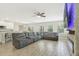 Bright living room with open floor plan features a ceiling fan and modern lighting at 1115 Oak Bluff Dr, Davenport, FL 33837
