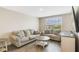 Bright living room with modern couches, a round table, and a large window at 1115 Oak Bluff Dr, Davenport, FL 33837