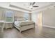 Bright main bedroom features a tray ceiling and connecting access to the en-suite bathroom at 1115 Oak Bluff Dr, Davenport, FL 33837