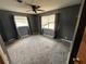 Bedroom with carpeted floors, ceiling fan and two windows at 1206 Olen Dr, Daytona Beach, FL 32117