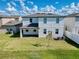 Lush backyard with a covered patio offering relaxation and outdoor enjoyment at 1210 Lone Palm Way, St Cloud, FL 34771