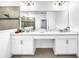 Bright bathroom featuring double sinks, granite countertops, white cabinets, and a glass-enclosed shower at 1210 Lone Palm Way, St Cloud, FL 34771