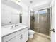 Bathroom features a modern sink vanity, a toilet, and a shower with glass doors at 1210 Lone Palm Way, St Cloud, FL 34771