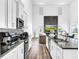Open concept kitchen with sleek countertops and stainless steel appliances at 1210 Lone Palm Way, St Cloud, FL 34771