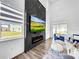 Cozy living room with large television and modern fireplace at 1210 Lone Palm Way, St Cloud, FL 34771