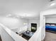 Bright living room with high ceilings and modern decor, overlooking comfortable seating and a bedroom with a view at 1210 Lone Palm Way, St Cloud, FL 34771
