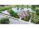 Overhead view of community clubhouse surrounded by a lake, palm trees, and parking at 1255 Marley Ln, Winter Springs, FL 32708