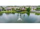 An aerial view of the community pool, townhomes, and a serene lake with a fountain at 1255 Marley Ln, Winter Springs, FL 32708
