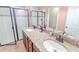 The bathroom has a granite counter top, double sinks and a glass-enclosed shower at 1255 Marley Ln, Winter Springs, FL 32708