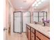 Bathroom featuring double sinks with granite countertop and sleek glass-enclosed shower at 1255 Marley Ln, Winter Springs, FL 32708