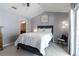 A comfortable bedroom with a queen bed, vaulted ceiling, ensuite bathroom and soft decor at 1255 Marley Ln, Winter Springs, FL 32708