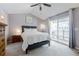 A cozy bedroom with a queen size bed, vaulted ceiling and access to a private balcony at 1255 Marley Ln, Winter Springs, FL 32708