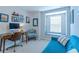 Bright home office featuring a work station and comfortable blue couch next to a window seat at 1255 Marley Ln, Winter Springs, FL 32708