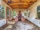 Open-air patio featuring a brick fireplace, arched doorway, and rustic exposed wood ceiling at 1263 Dunbar St, Altamonte Springs, FL 32701