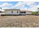 Rear exterior of the house with a view of the backyard and some greenery at 1312 Catalina Blvd, Deltona, FL 32725