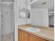 Bathroom with updated vanity, mirror, and shower with glass door at 1312 Catalina Blvd, Deltona, FL 32725