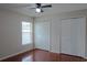 Bedroom featuring wood look flooring, window, and double door closets at 1312 Catalina Blvd, Deltona, FL 32725