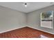 Bright bedroom featuring a window and wood-look tile flooring at 1312 Catalina Blvd, Deltona, FL 32725