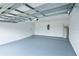 A spacious garage with gray flooring, overhead lighting, and a water heater provides ample storage space at 1312 Catalina Blvd, Deltona, FL 32725