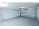 Spacious garage interior with a white insulated door and painted floor at 1312 Catalina Blvd, Deltona, FL 32725