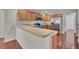 Bright kitchen features stainless appliances, wood cabinets, and breakfast bar seating at 1312 Catalina Blvd, Deltona, FL 32725