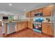 Modern kitchen with stainless steel appliances, bright-blue oven, and ample counter space at 1312 Catalina Blvd, Deltona, FL 32725